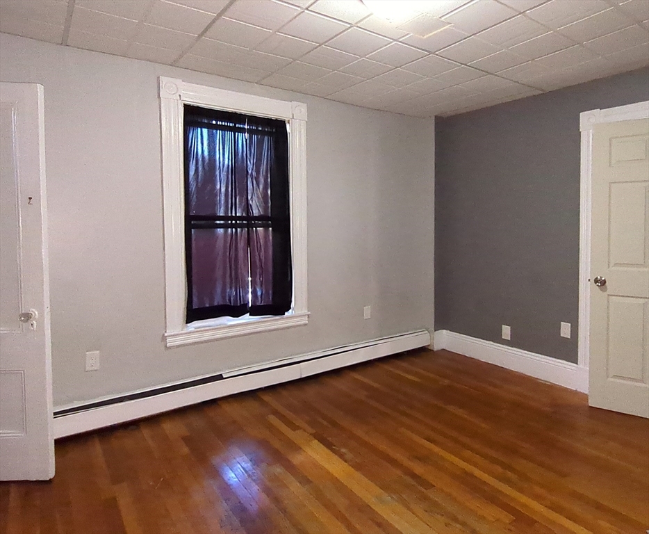 7 Cherry Street Lynn, MA 01902 - Photo 23 of 42 a view of an empty room with wooden floor and a window