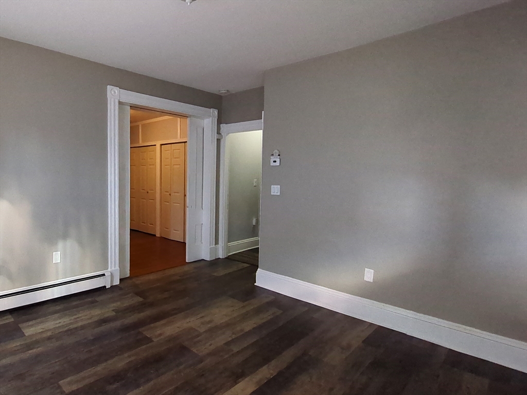 7 Cherry Street Lynn, MA 01902 - Photo 25 of 42 a view of an empty room with wooden floor and a window