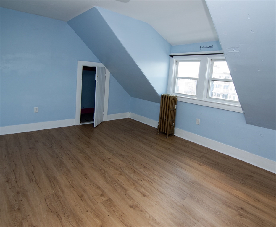 7 Cherry Street Lynn, MA 01902 - Photo 29 of 42 an empty room with wooden floor and windows