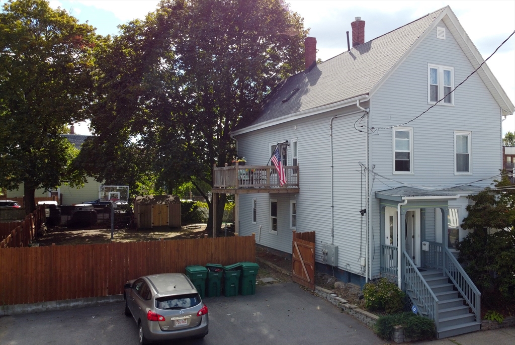 7 Cherry Street Lynn, MA 01902 - Photo 3 of 42 a front view of a house with a yard and car parked