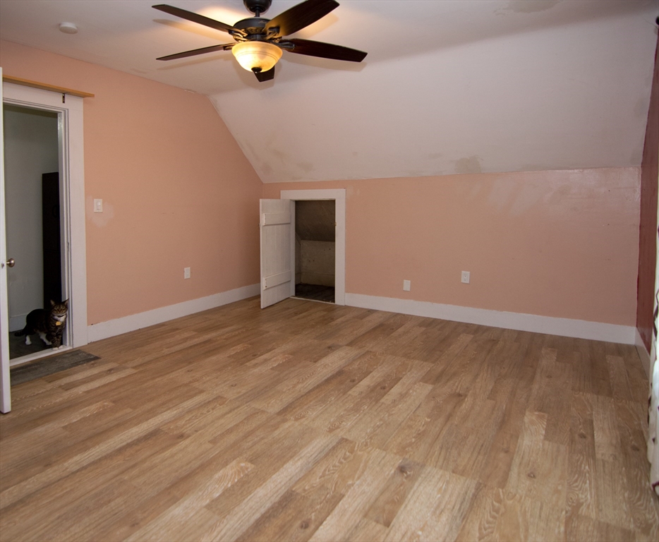 7 Cherry Street Lynn, MA 01902 - Photo 31 of 42 wooden floor in an empty room with a ceiling fan