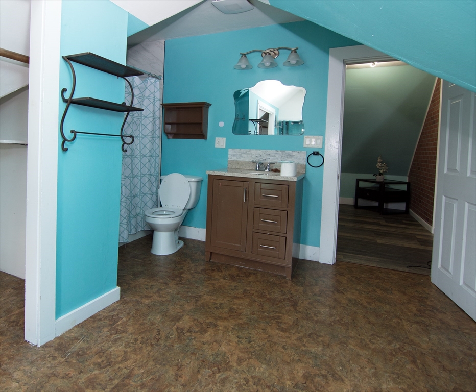 7 Cherry Street Lynn, MA 01902 - Photo 32 of 42 a bathroom with a sink a toilet and a mirror