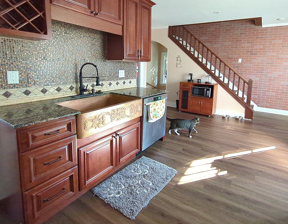 7 Cherry Street Lynn, MA 01902 - Photo 4 of 42 a kitchen with stainless steel appliances granite countertop a sink stove and cabinets