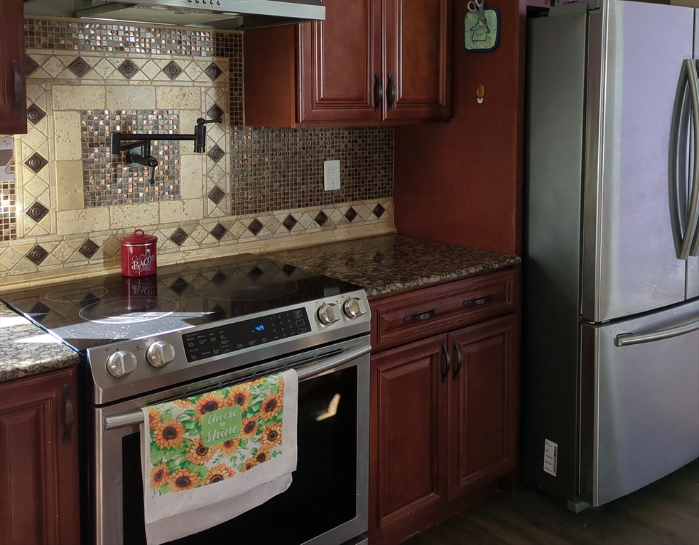 7 Cherry Street Lynn, MA 01902 - Photo 6 of 42 a kitchen with stainless steel appliances granite countertop a stove and a microwave