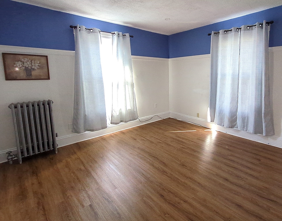 7 Cherry Street Lynn, MA 01902 - Photo 10 of 42 an empty room with wooden floor and windows