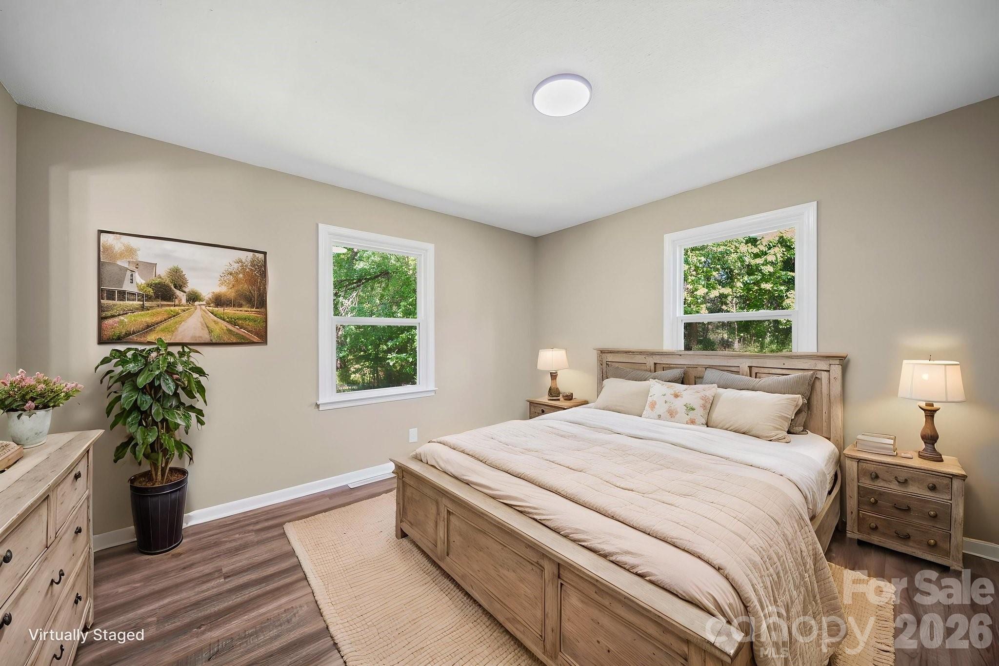 502 Geroid Street Salisbury, NC 28144 - Photo 13 of 31 a bedroom with a bed and a potted plant next to a window