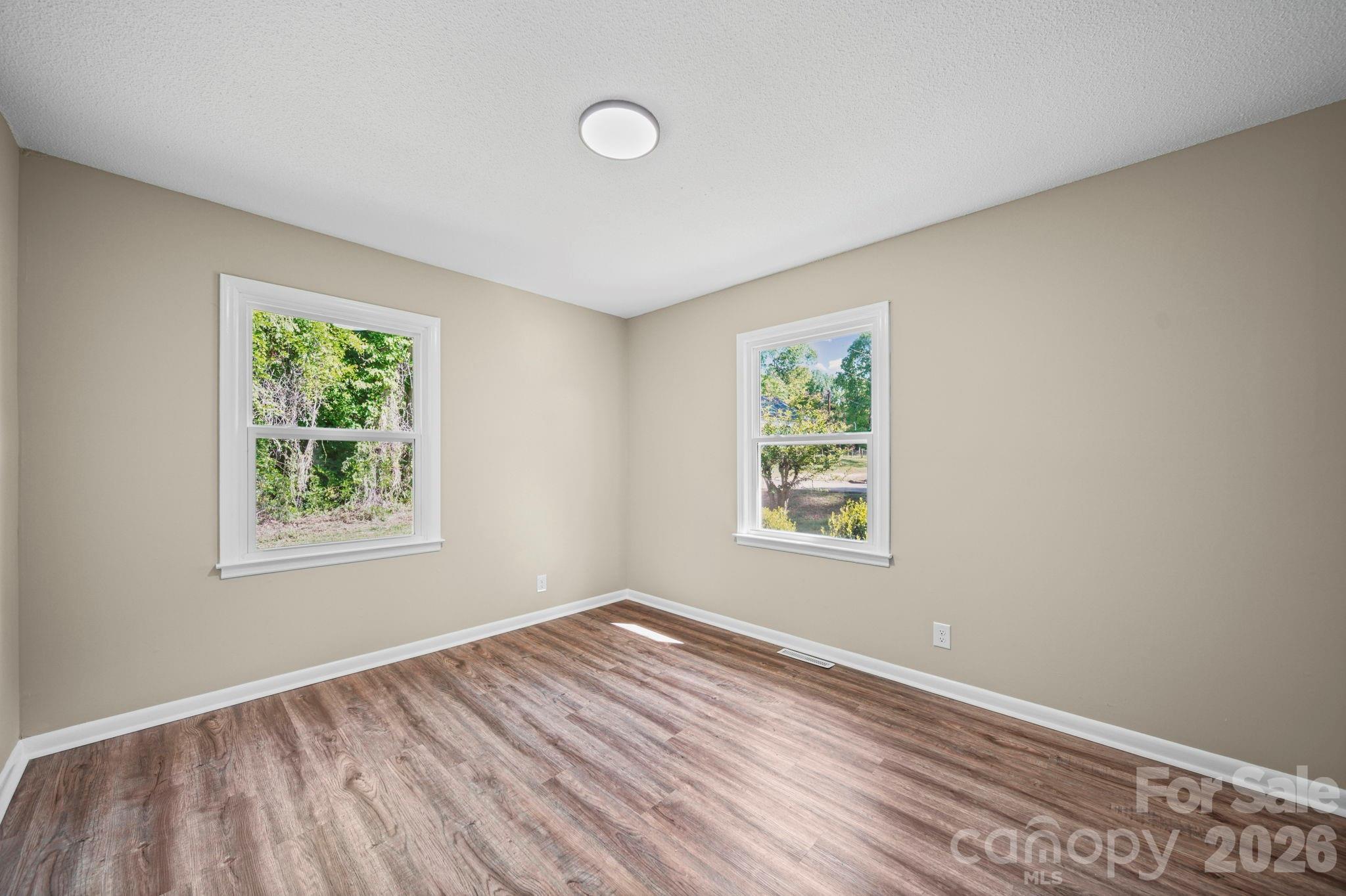 502 Geroid Street Salisbury, NC 28144 - Photo 14 of 31 a view of an empty room with wooden floor and window