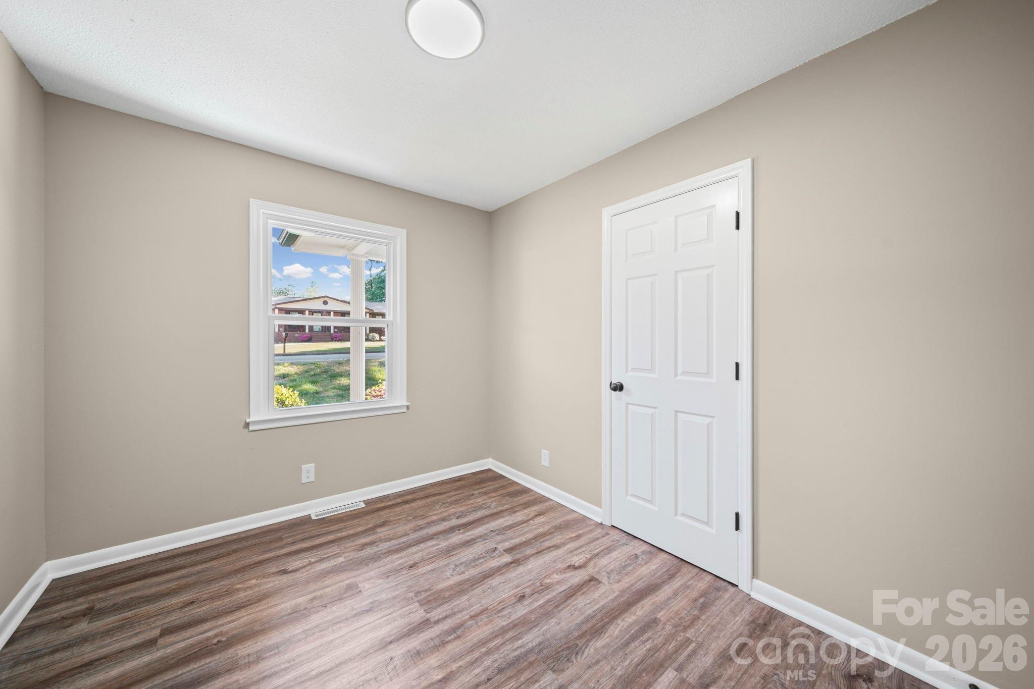 502 Geroid Street Salisbury, NC 28144 - Photo 18 of 31 a view of an empty room with wooden floor and a window