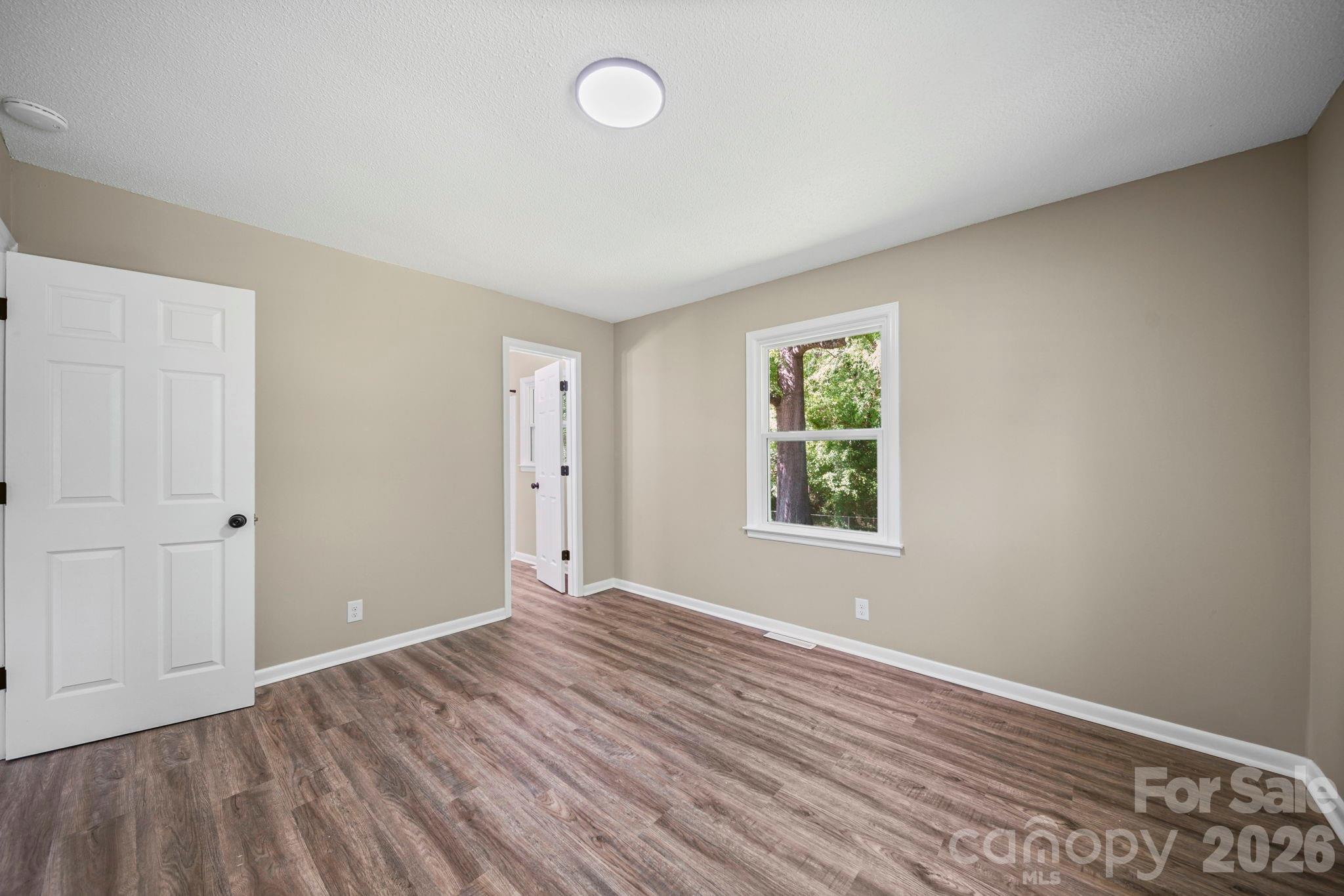502 Geroid Street Salisbury, NC 28144 - Photo 19 of 31 an empty room with wooden floor and windows