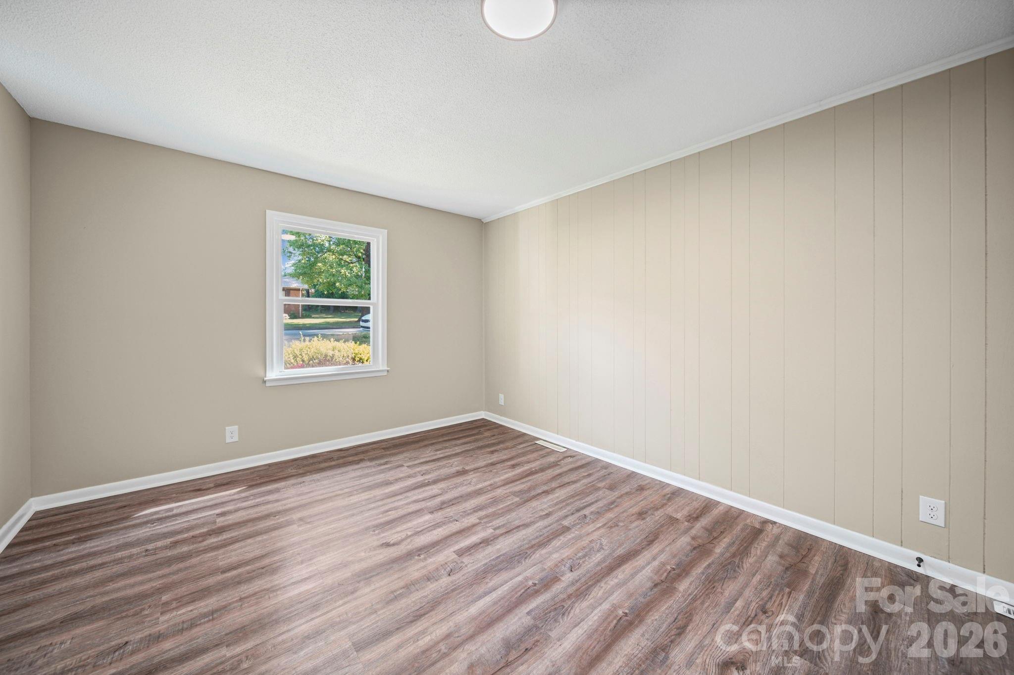 502 Geroid Street Salisbury, NC 28144 - Photo 22 of 31 an empty room with wooden floor and windows