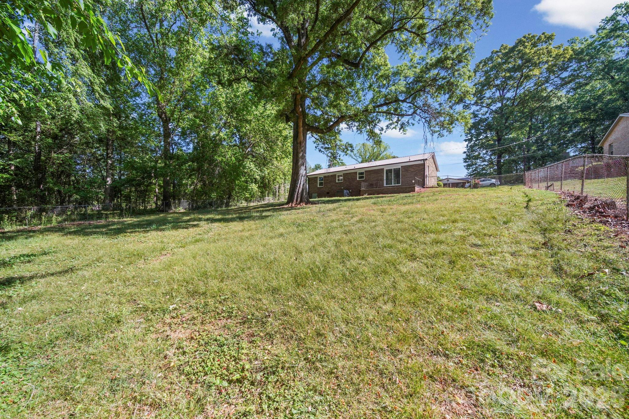 502 Geroid Street Salisbury, NC 28144 - Photo 29 of 31 a backyard of a house with trees and entertaining space