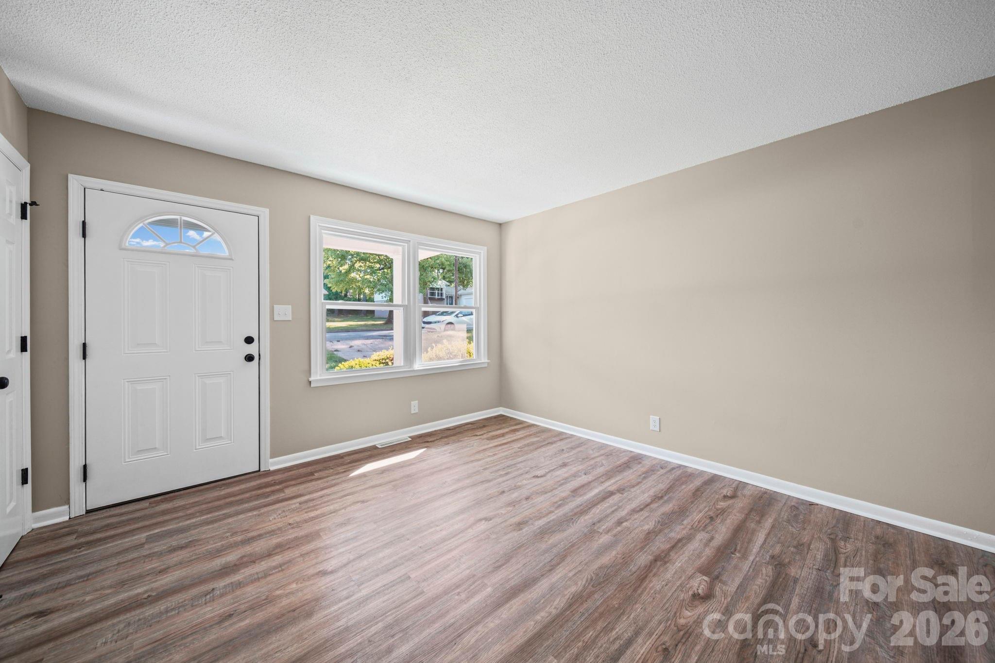 502 Geroid Street Salisbury, NC 28144 - Photo 5 of 31 a view of an empty room with wooden floor and a window
