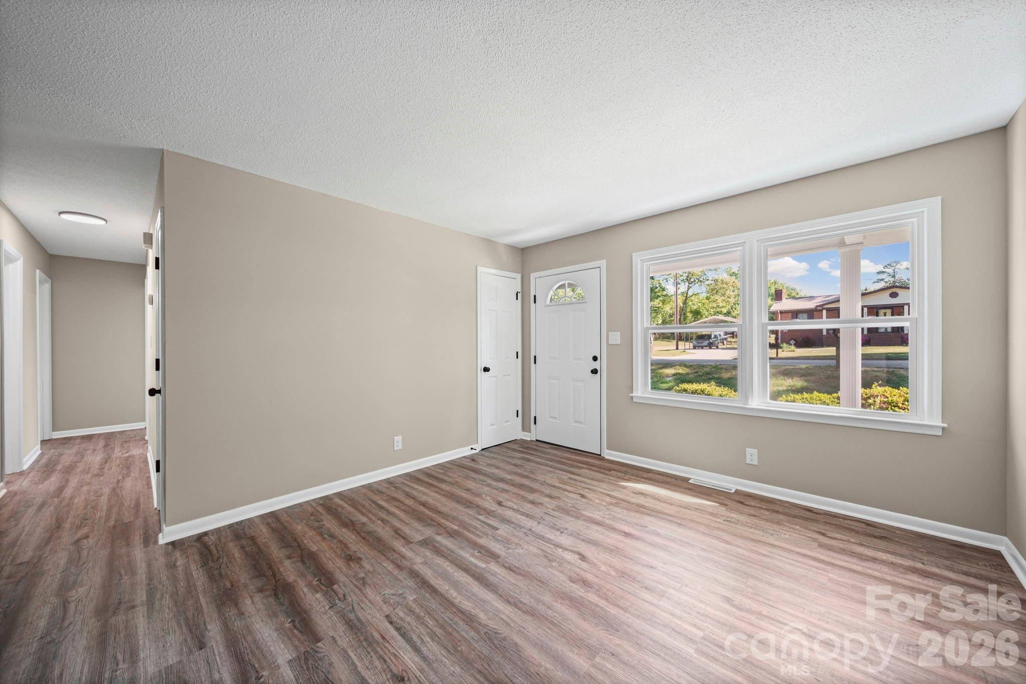 502 Geroid Street Salisbury, NC 28144 - Photo 6 of 31 a view of an empty room with wooden floor and a window