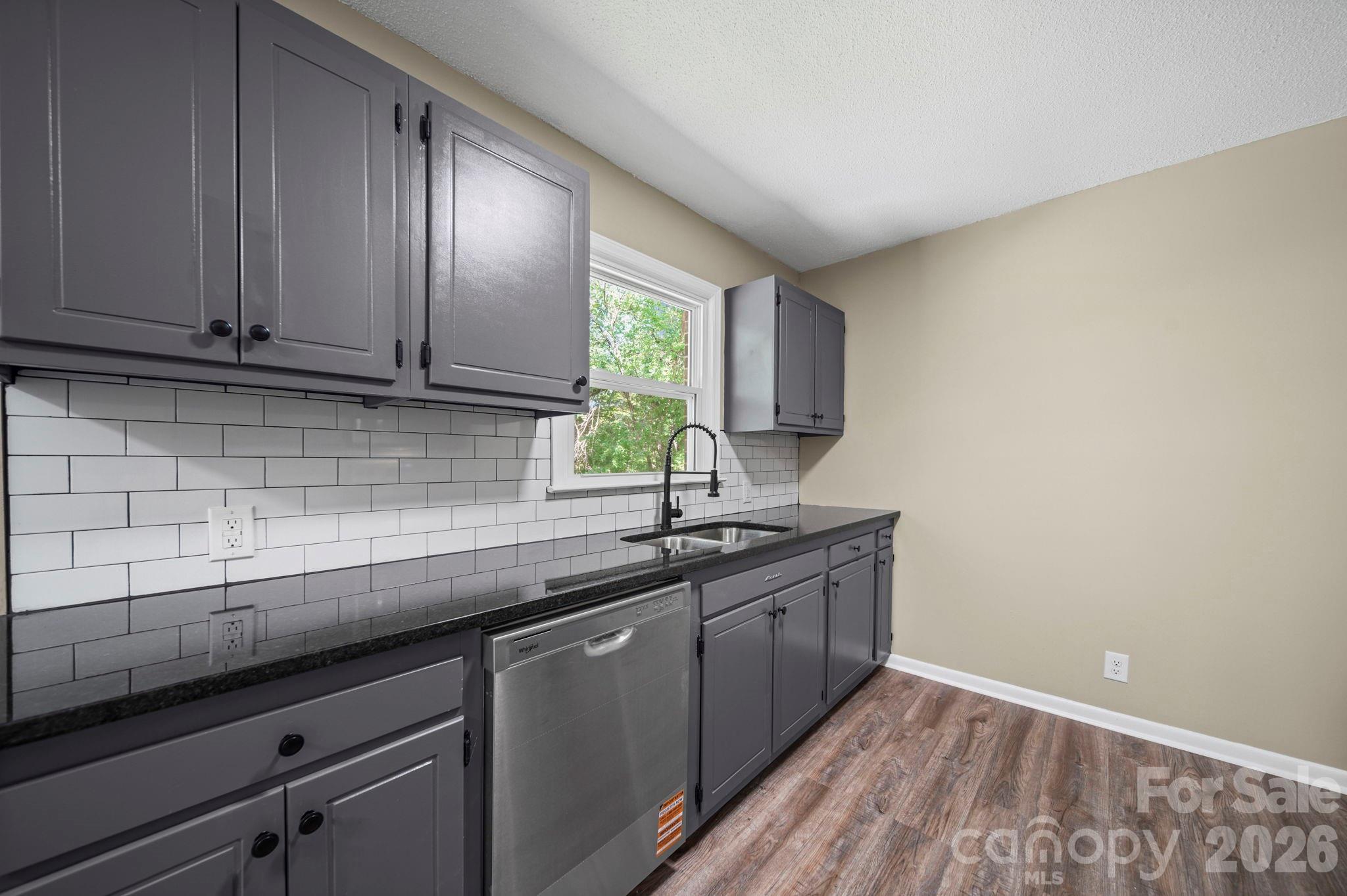 502 Geroid Street Salisbury, NC 28144 - Photo 8 of 31 a kitchen with granite countertop cabinets sink and window