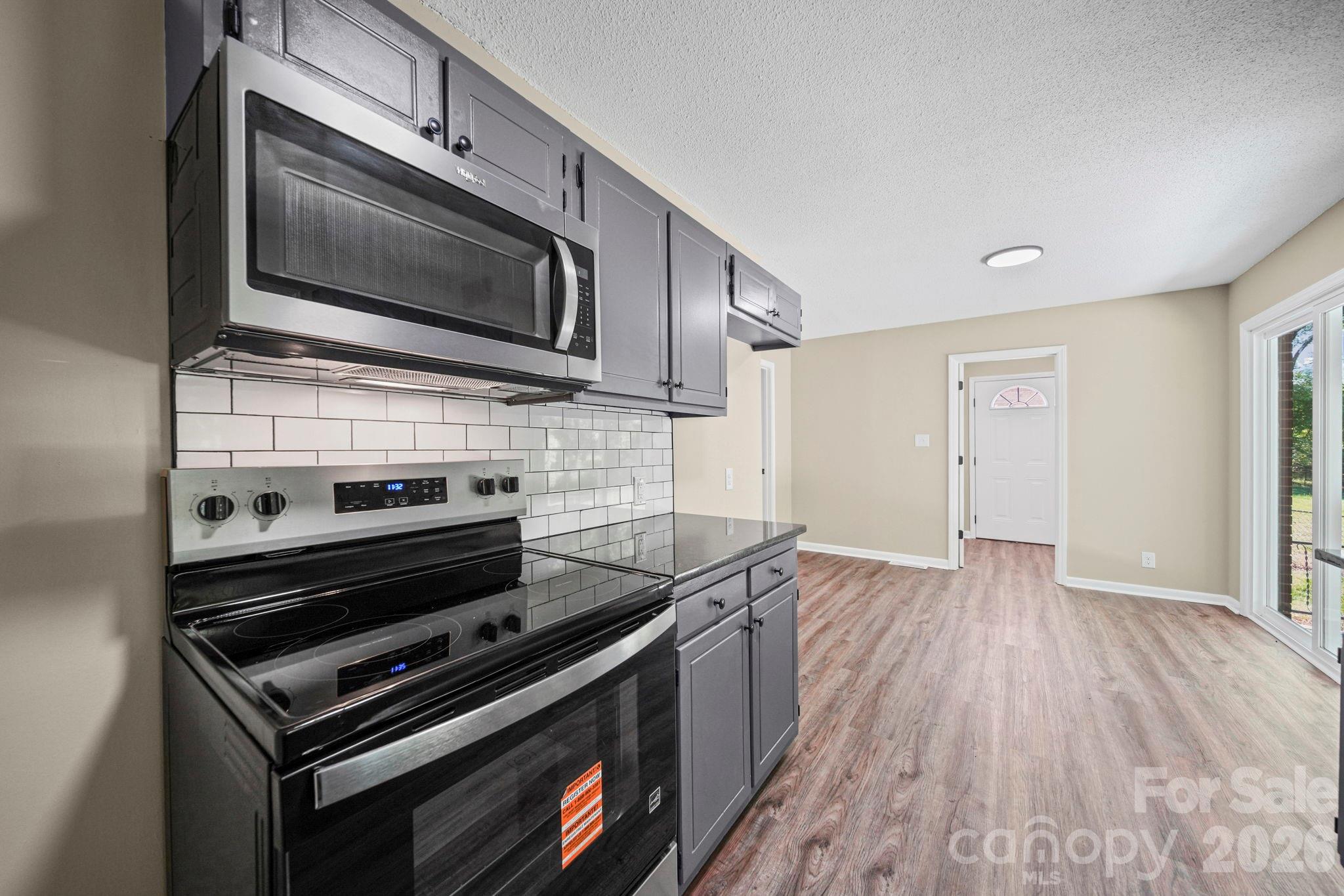 502 Geroid Street Salisbury, NC 28144 - Photo 10 of 31 a kitchen with wooden floors and stainless steel appliances