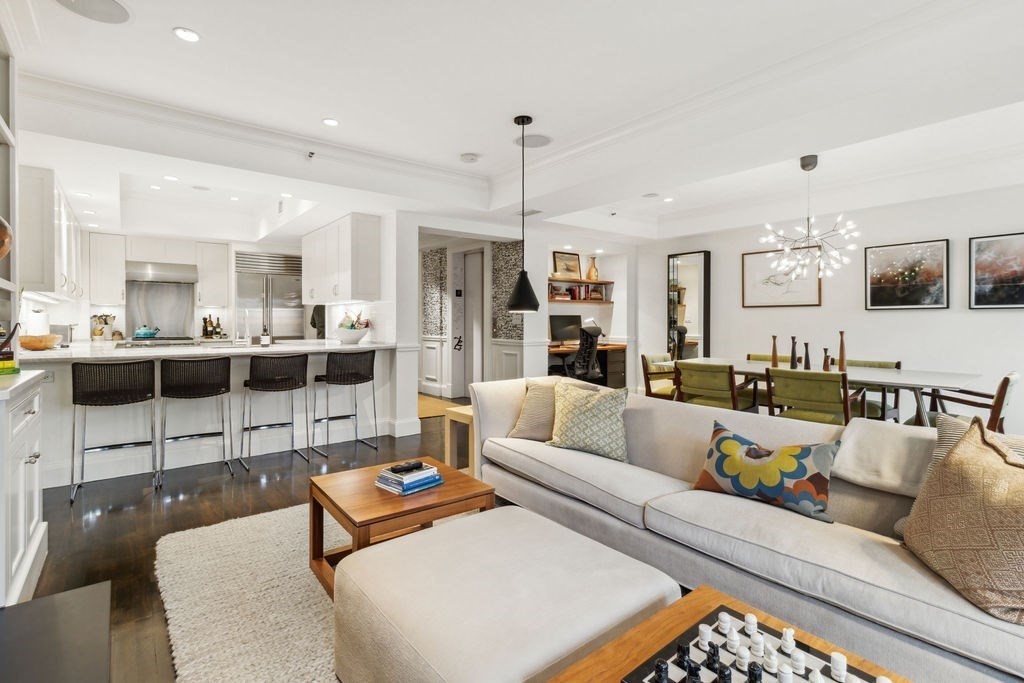 a living room with furniture and view of kitchen