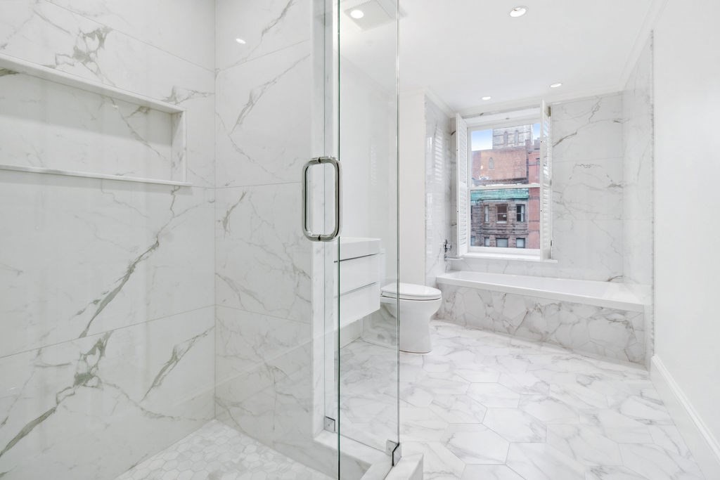157 Newbury Street, Unit 4 Boston, MA 02116 - Photo 13 of 26 a bathroom with a bathtub and shower
