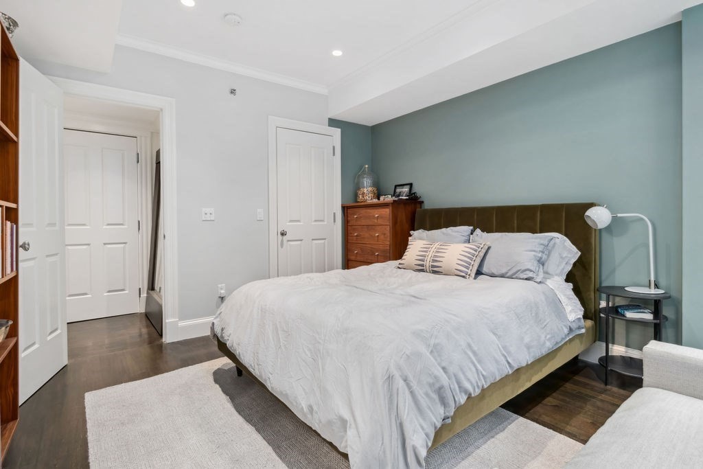 157 Newbury Street, Unit 4 Boston, MA 02116 - Photo 16 of 26 a bed room with a bed and wooden floor