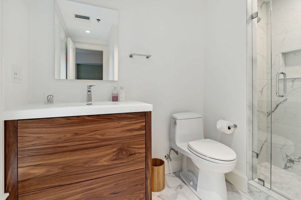 157 Newbury Street, Unit 4 Boston, MA 02116 - Photo 18 of 26 a bathroom with a toilet sink and mirror