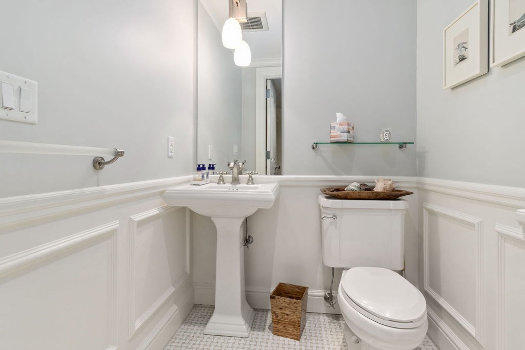157 Newbury Street, Unit 4 Boston, MA 02116 - Photo 22 of 26 a bathroom with a sink a toilet and mirror