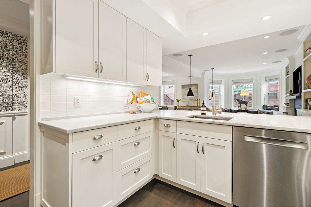 157 Newbury Street, Unit 4 Boston, MA 02116 - Photo 7 of 26 a kitchen with white cabinets and sink