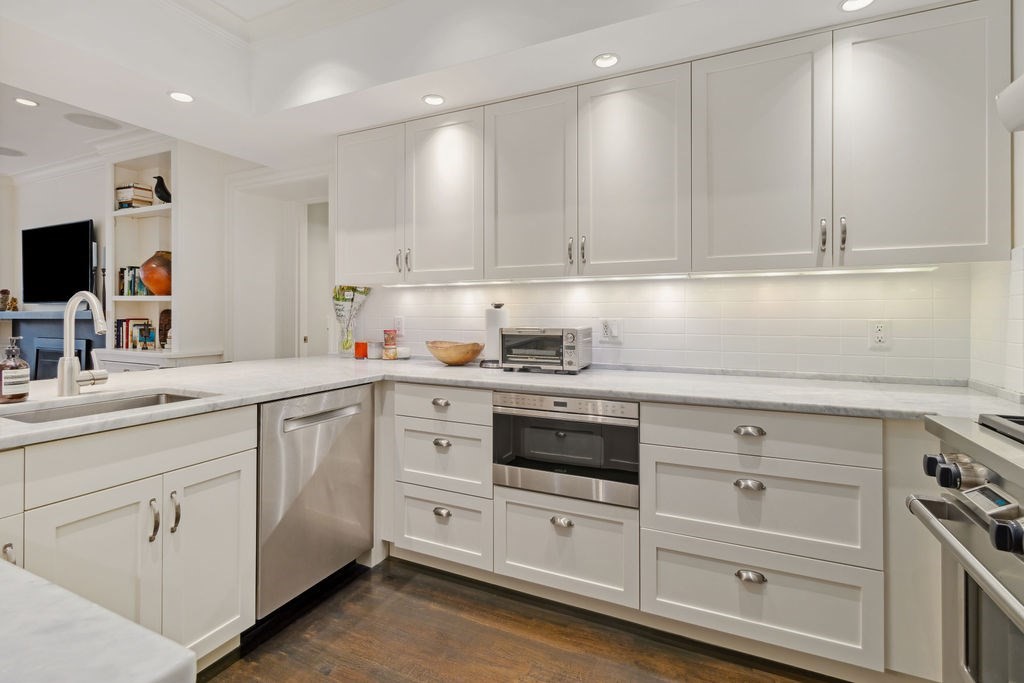 157 Newbury Street, Unit 4 Boston, MA 02116 - Photo 8 of 26 a kitchen with white cabinets and white appliances