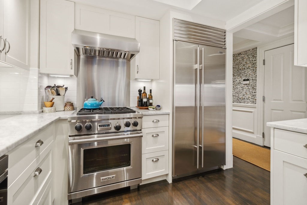 157 Newbury Street, Unit 4 Boston, MA 02116 - Photo 9 of 26 a kitchen with cabinets stainless steel appliances and wooden floor