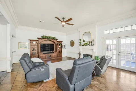 a living room with furniture and a flat screen tv with wooden floor
