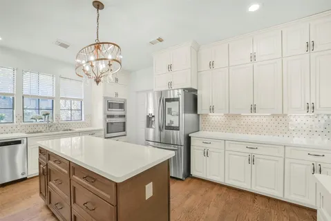 a kitchen with a sink stove and microwave