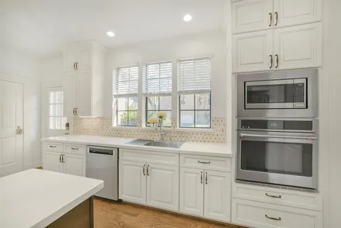 a view with granite countertop a sink and a window