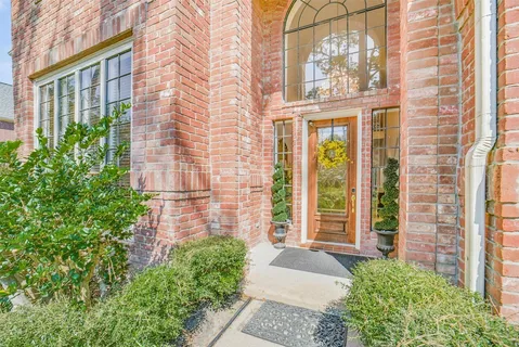 front view of a brick house with a large window