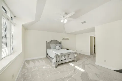 a bedroom with a bed and window