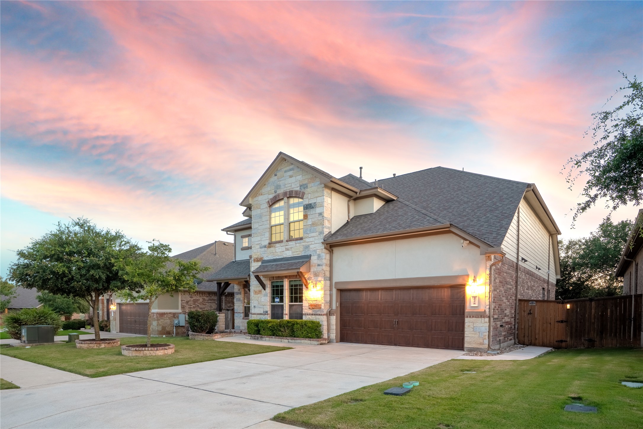 228 Lockhart Loop Georgetown, TX 78628 - Photo 5 of 37 View of front of house with stone siding, an attached garage, driveway, and a shingled roof