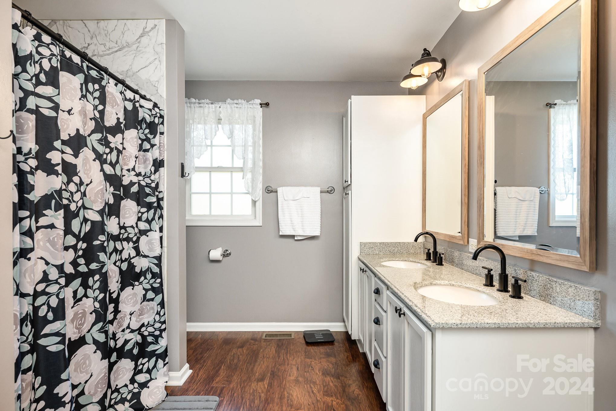 256 Hemlock Road Cleveland, NC 27013 - Photo 13 of 32 a bathroom with a granite countertop sink and a large mirror