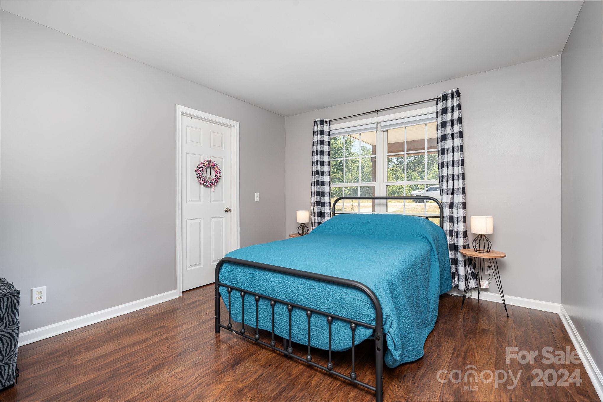 256 Hemlock Road Cleveland, NC 27013 - Photo 14 of 32 a bedroom with a bed and wooden floor