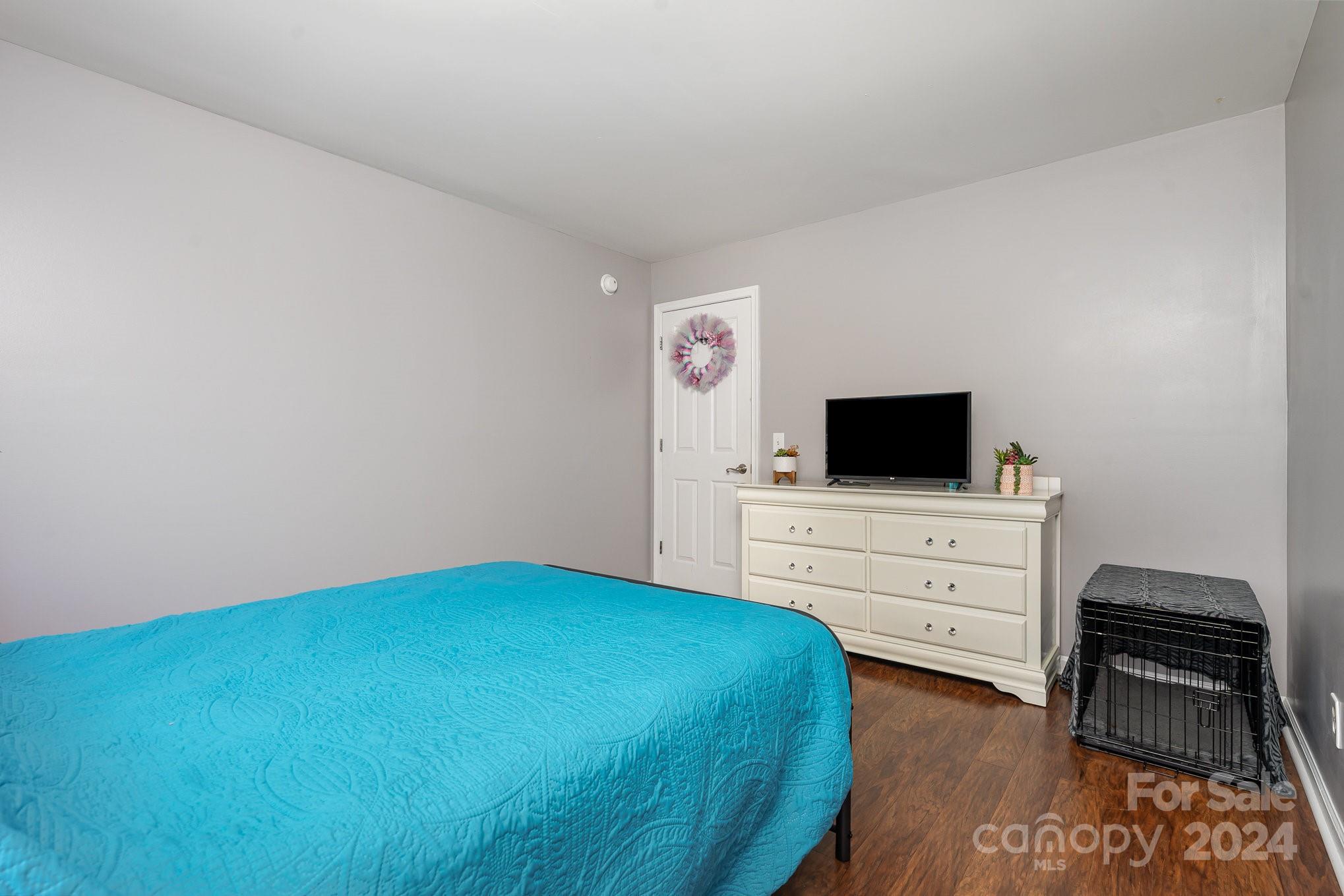 256 Hemlock Road Cleveland, NC 27013 - Photo 15 of 32 a bedroom with a bed and flat screen tv