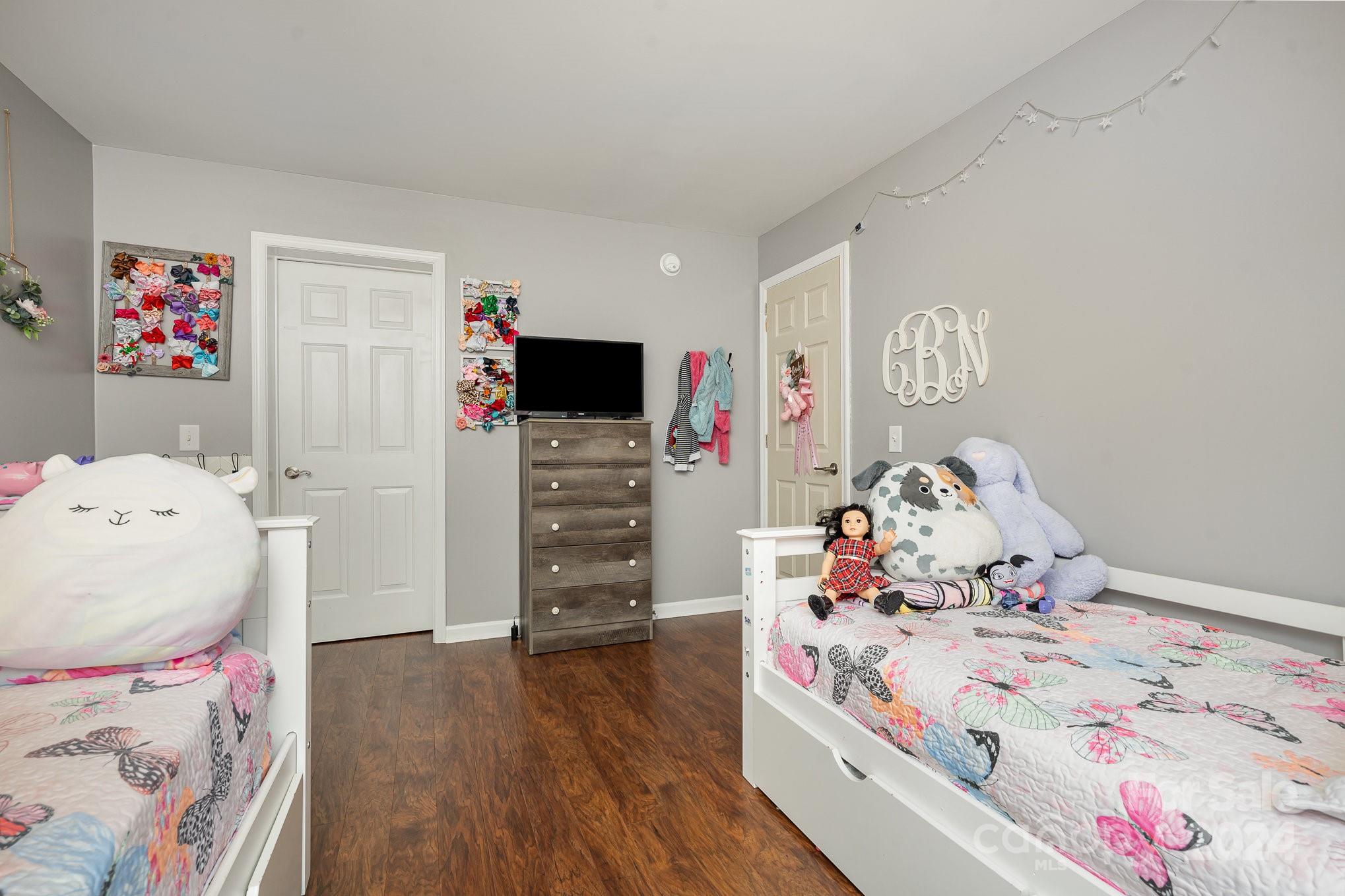 256 Hemlock Road Cleveland, NC 27013 - Photo 17 of 32 a bedroom with a bed and wooden floor