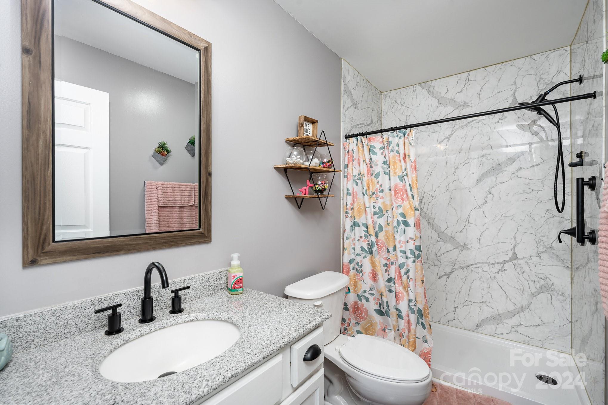 256 Hemlock Road Cleveland, NC 27013 - Photo 18 of 32 a bathroom with a sink toilet and shower