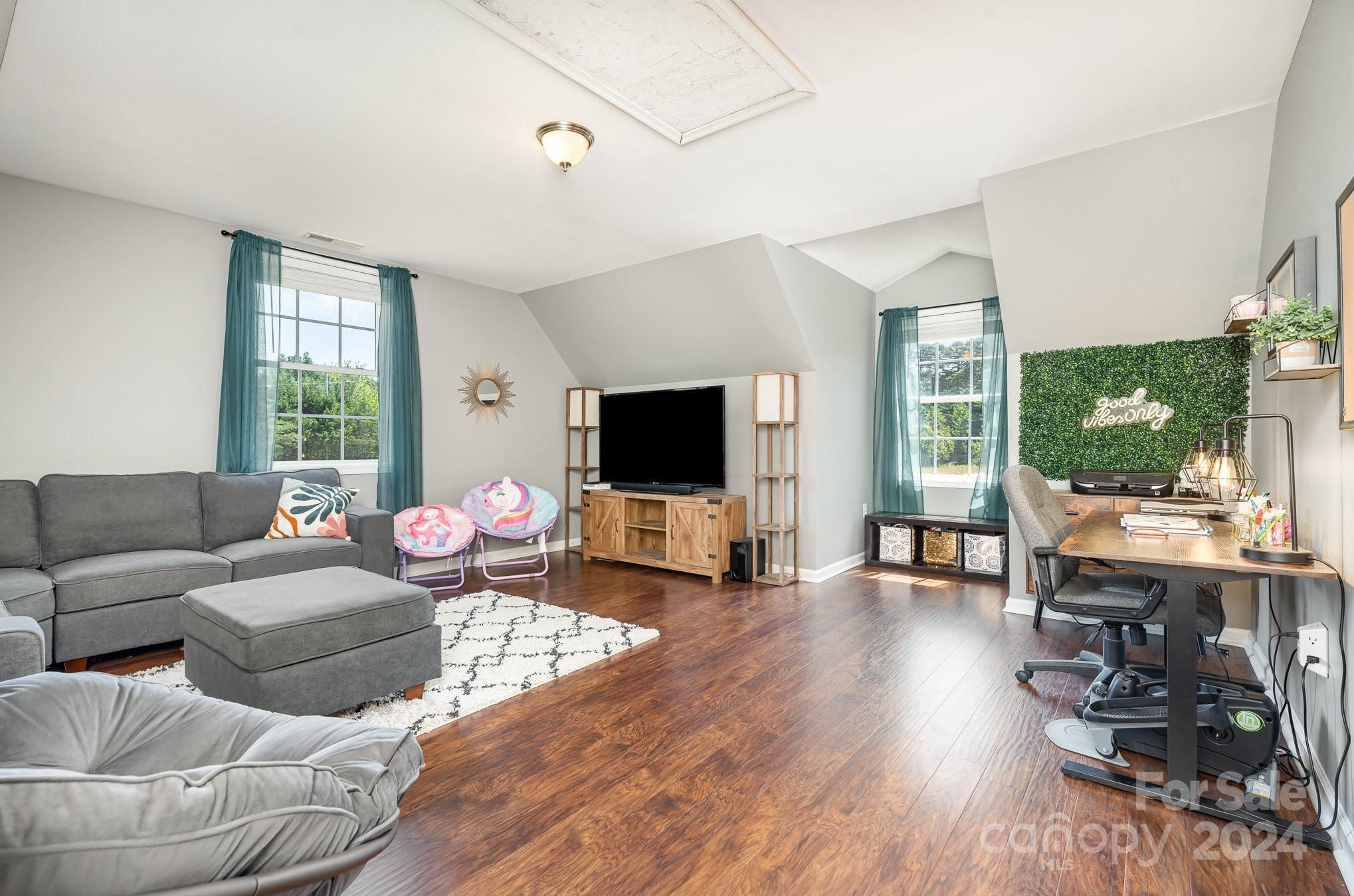 256 Hemlock Road Cleveland, NC 27013 - Photo 20 of 32 a living room with furniture and a flat screen tv