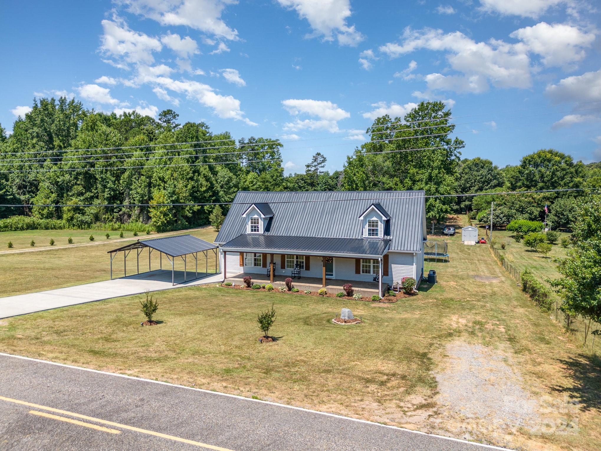 256 Hemlock Road Cleveland, NC 27013 - Photo 2 of 32 a view of a house with swimming pool and sitting area