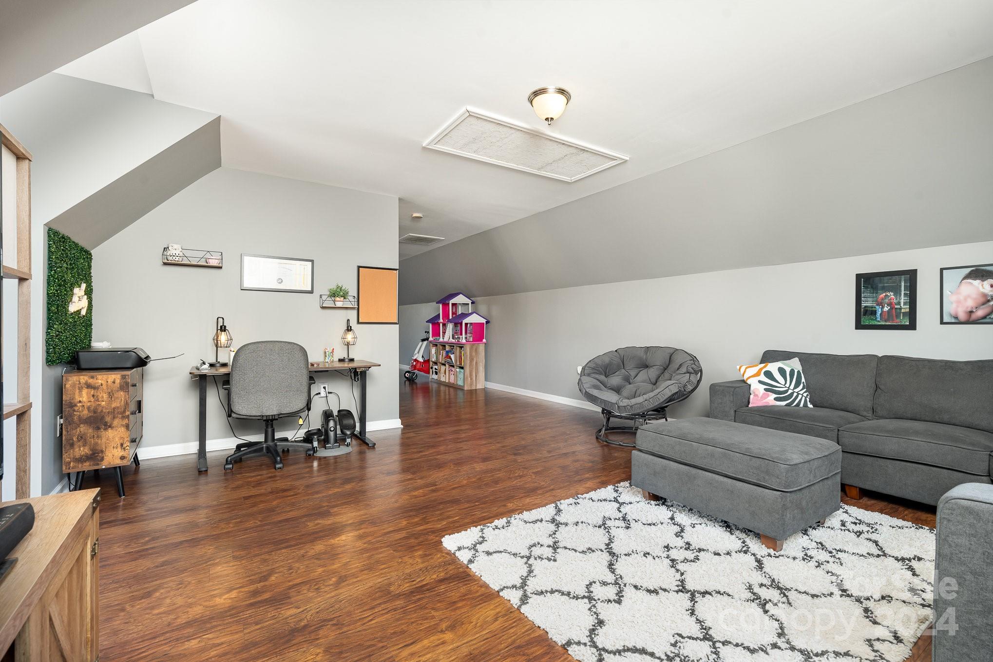 256 Hemlock Road Cleveland, NC 27013 - Photo 21 of 32 a living room with furniture and a wooden floor