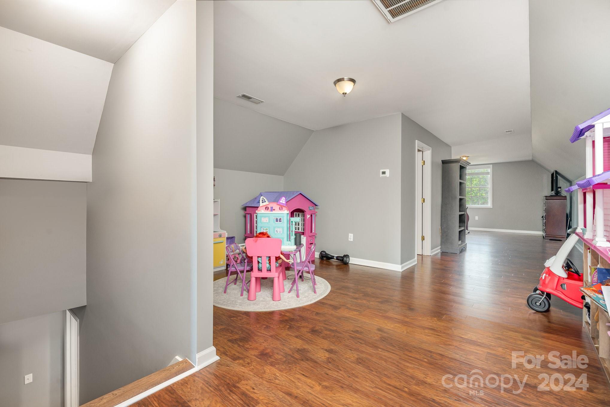 256 Hemlock Road Cleveland, NC 27013 - Photo 22 of 32 a play room with furniture and wooden floor