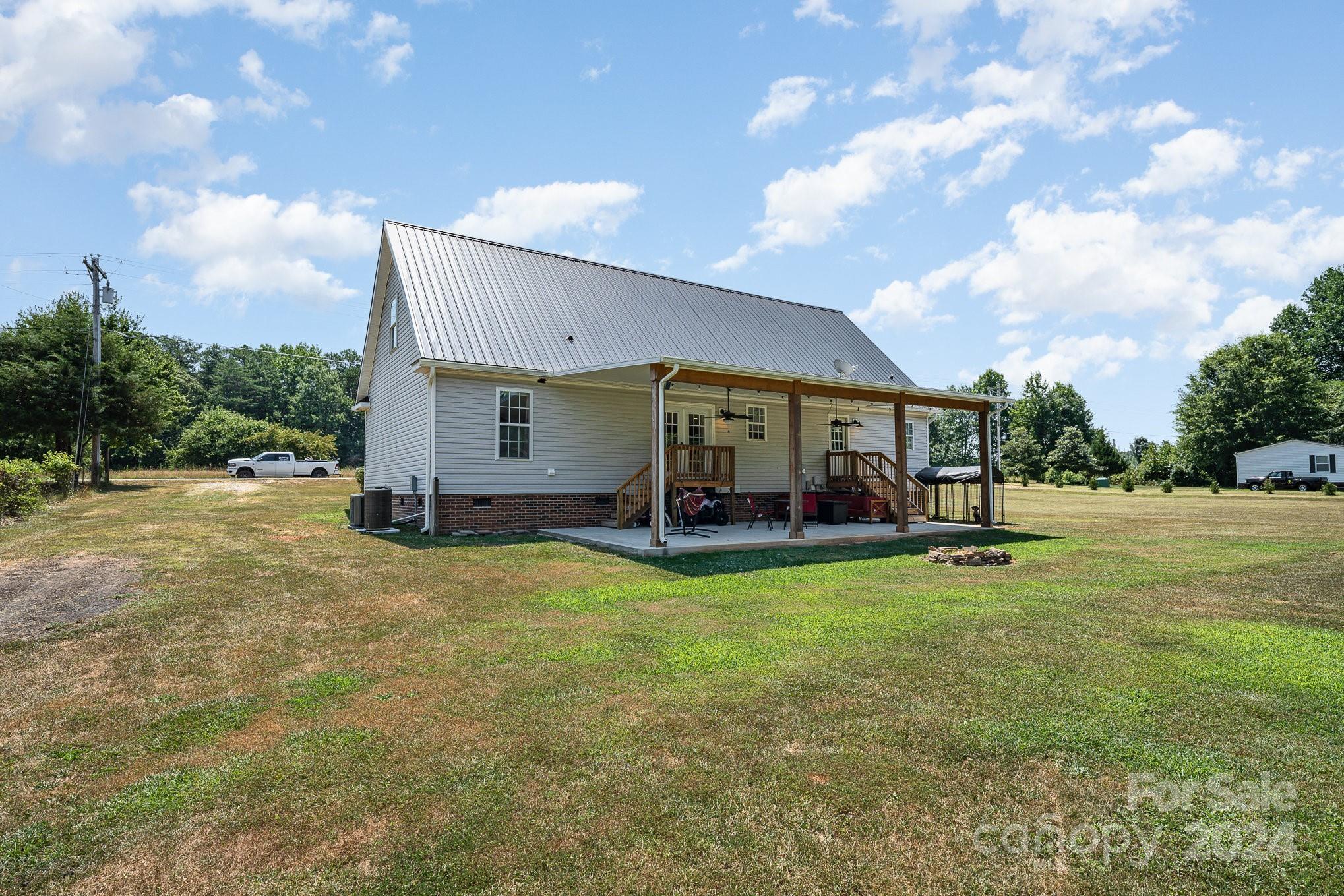 256 Hemlock Road Cleveland, NC 27013 - Photo 26 of 32 a view of a house with backyard porch and sitting area