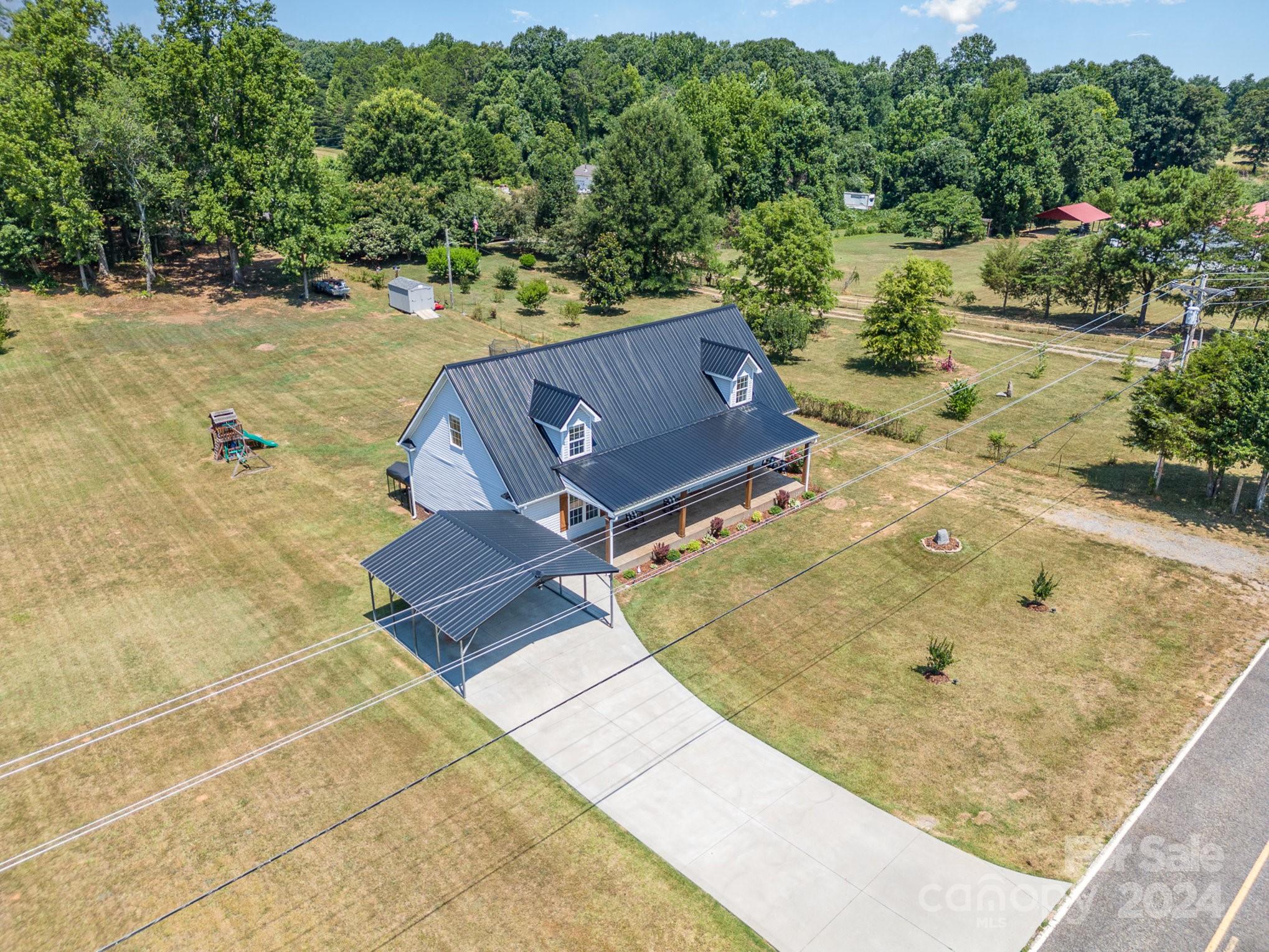 256 Hemlock Road Cleveland, NC 27013 - Photo 30 of 32 an aerial view of a house with a yard and lake view