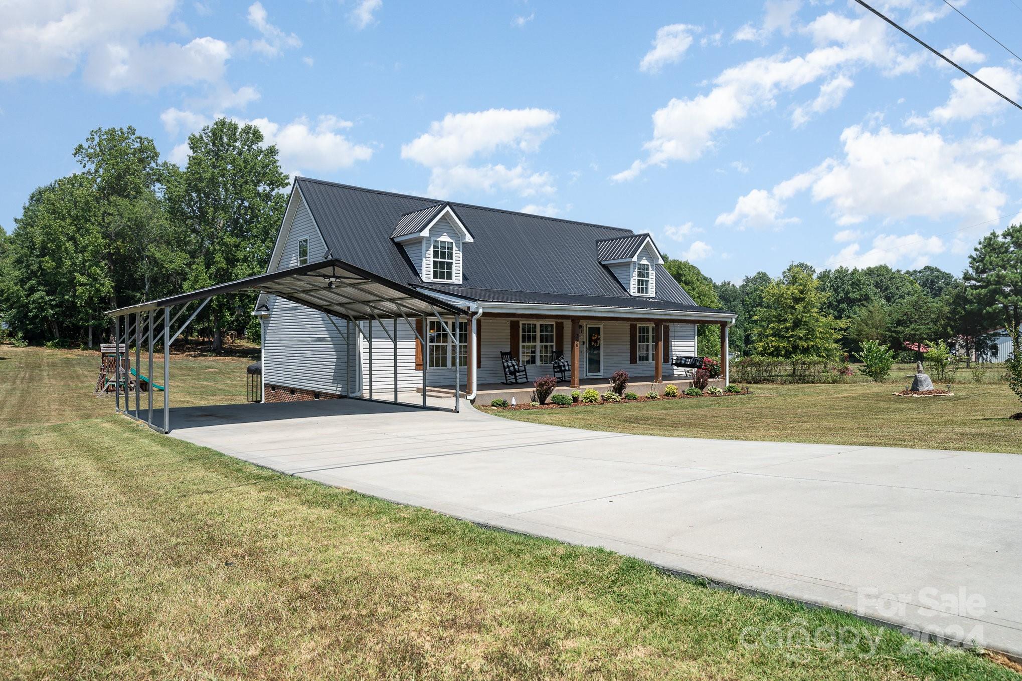 256 Hemlock Road Cleveland, NC 27013 - Photo 3 of 32 a front view of a house with swimming pool and dining garden