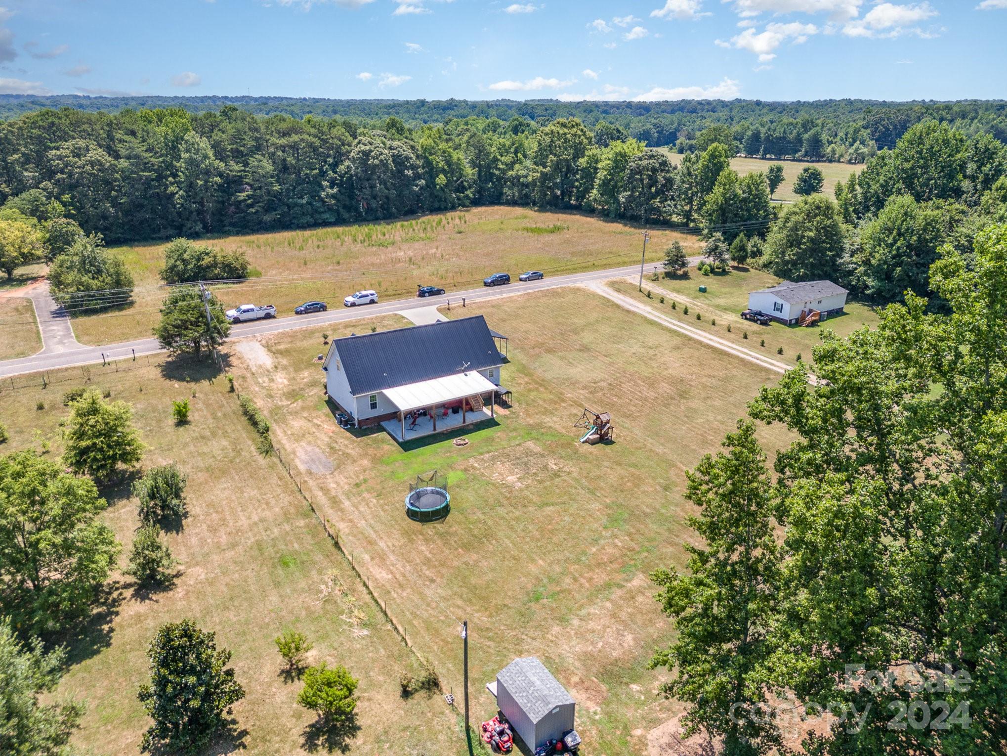 256 Hemlock Road Cleveland, NC 27013 - Photo 32 of 32 a view of a big yard with table and chairs