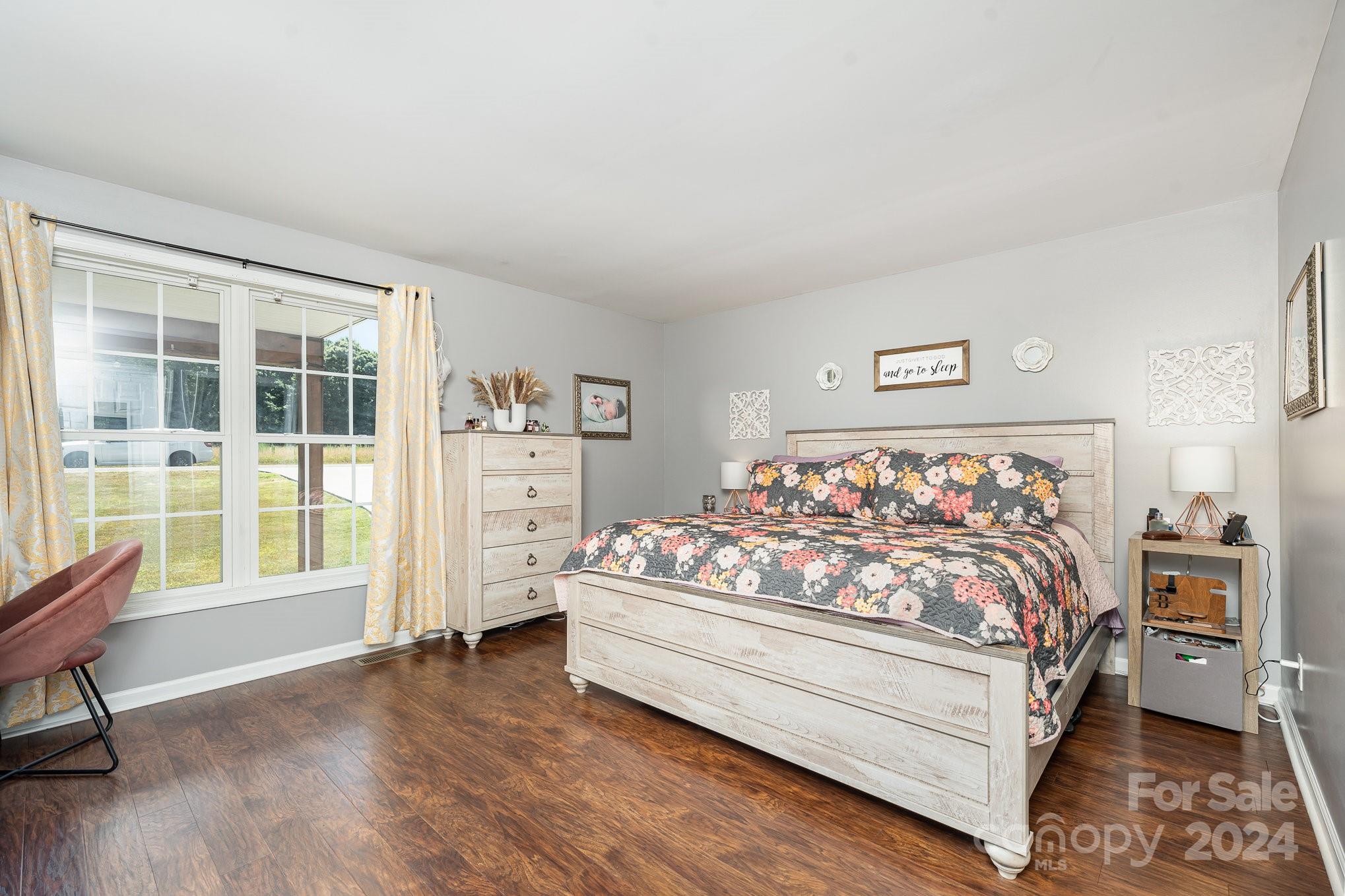 256 Hemlock Road Cleveland, NC 27013 - Photo 10 of 32 a bed sitting in a bedroom next to a window with a dresser