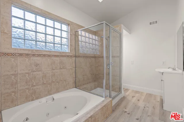 a bathroom with a bathtub and a shower
