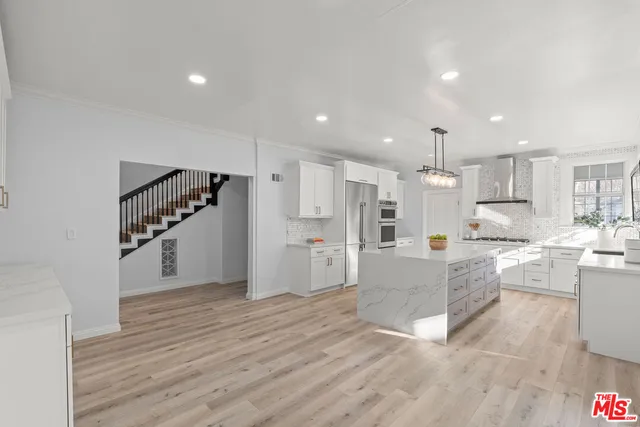 a view of kitchen with wooden floor and electronic appliances