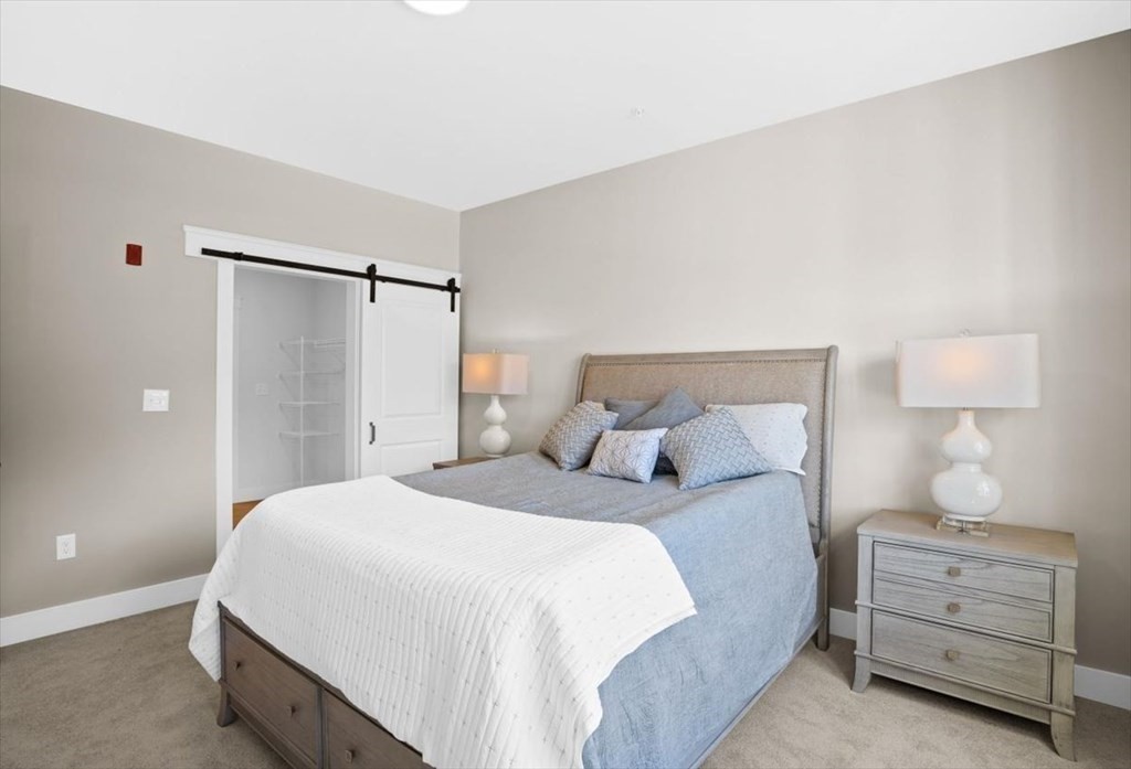57 Long Point Road, Unit 208 Lakeville, MA 02347 - Photo 6 of 27 a bedroom with a bed and a night stand